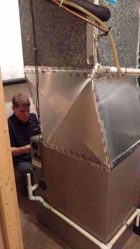An employee working on a heating system