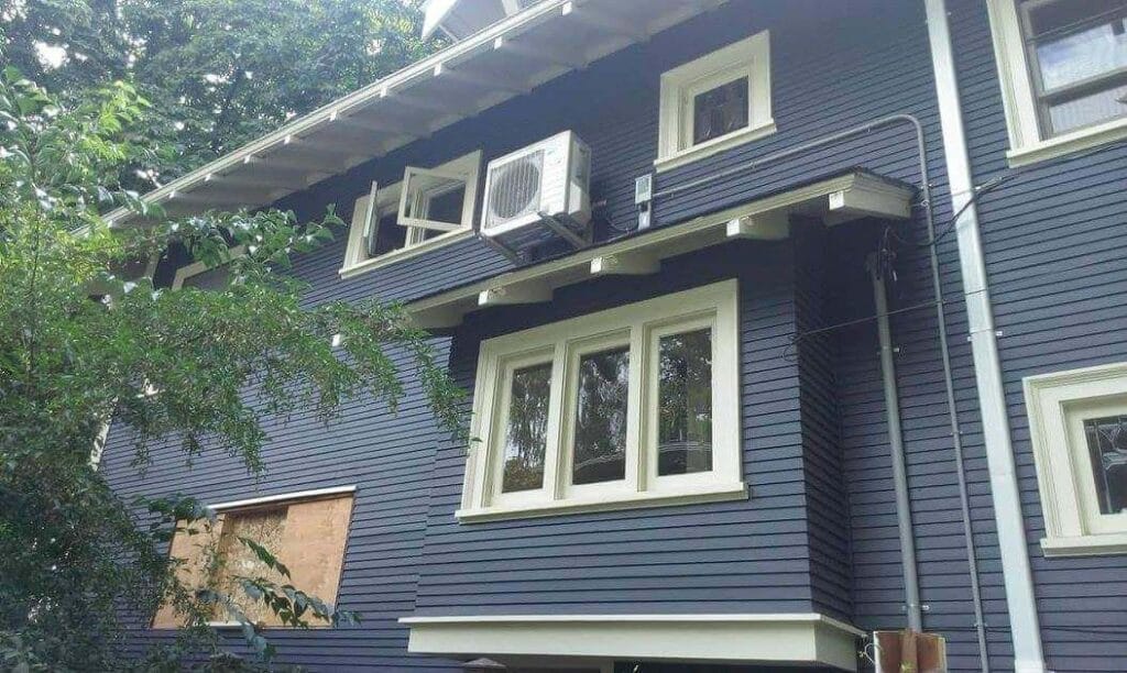 An exterior of a house with an AC unit